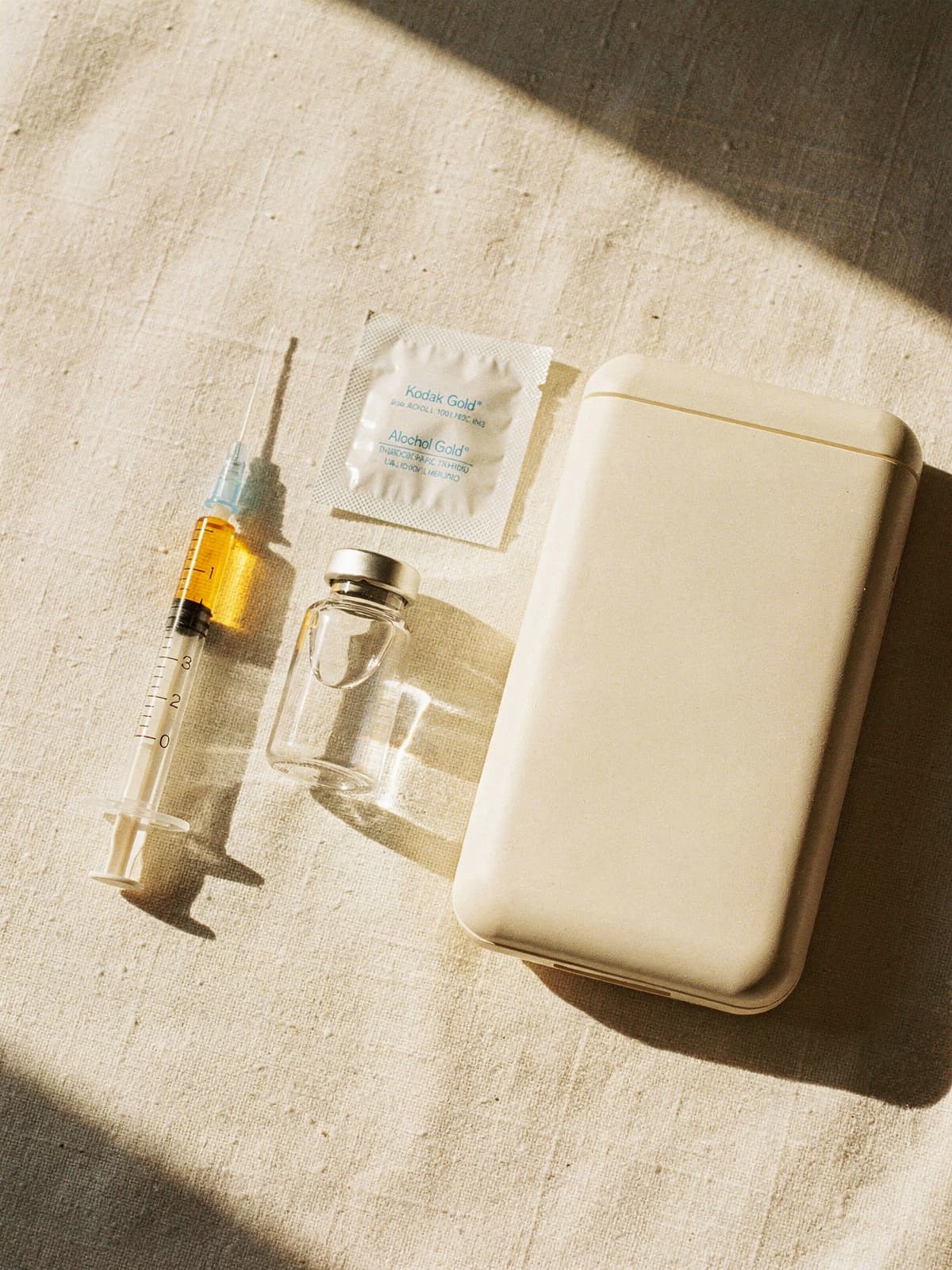 Unbranded dual-action treatment kit on cream linen in bright morning sunlight
